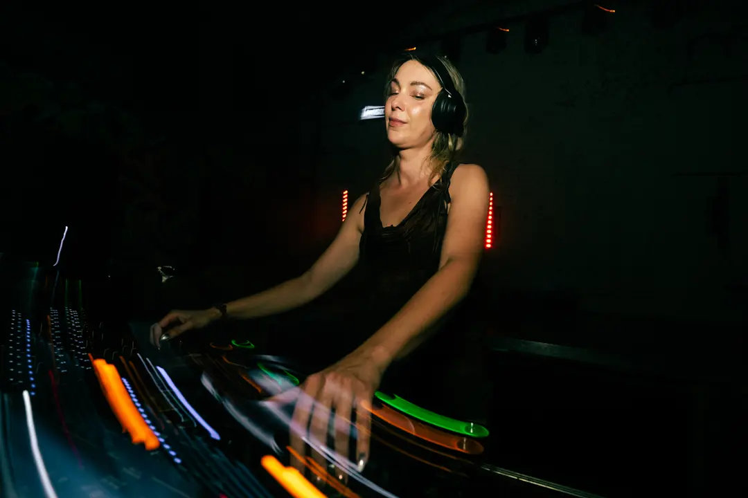 Anastasia Kristensen's hands blurred in motion across the mixer faders, the booth lights streaking behind them